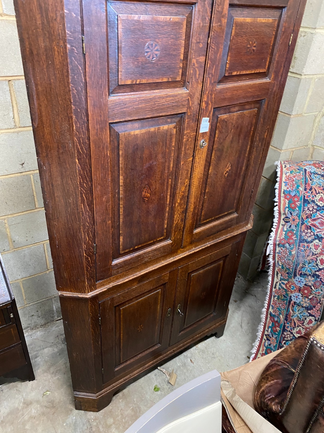 A George III mahogany banded oak standing corner cabinet, width 118cm, depth 64cm, height 224cm